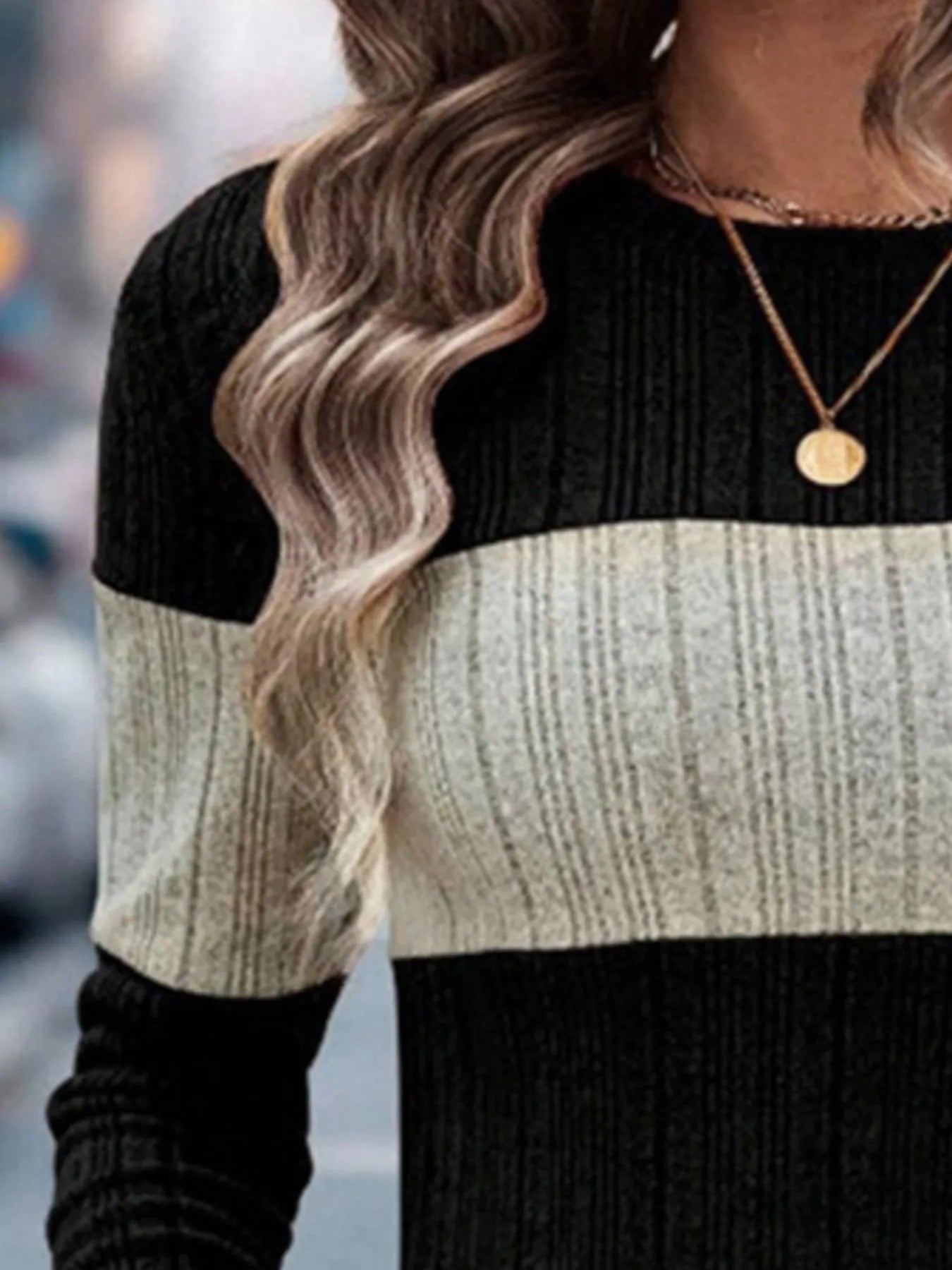 Black and heathered cream color-block sweater with ribbed round neckline