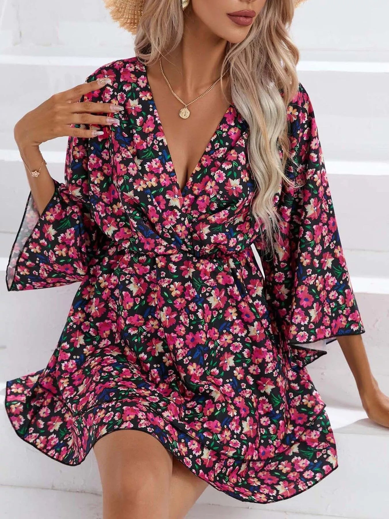 Floral mini dress with V-neck, long sleeves, and layered ruffle hem in dark print