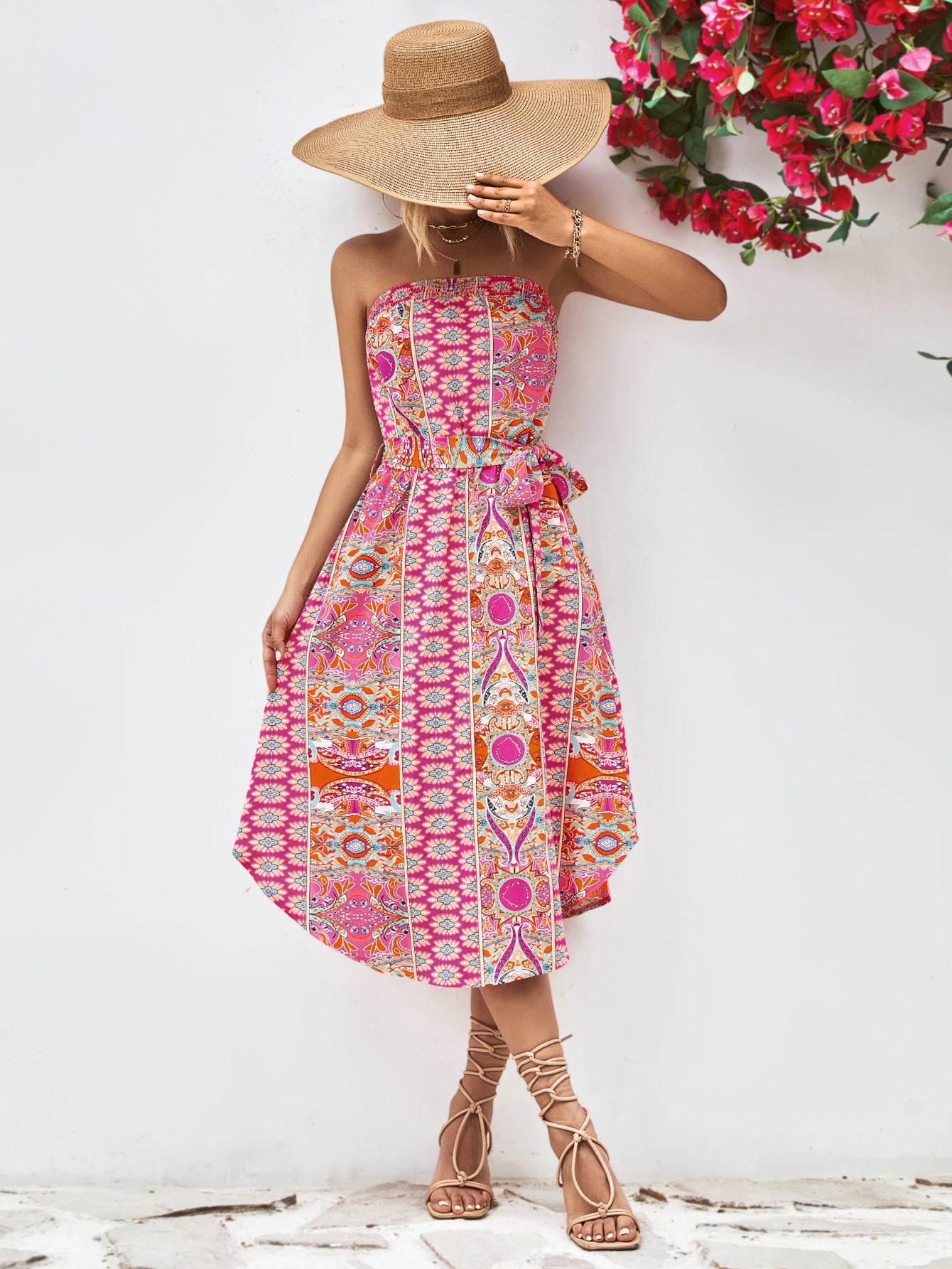 Hot pink strapless tie-belt dress with vibrant geometric print, gathered waist, midi