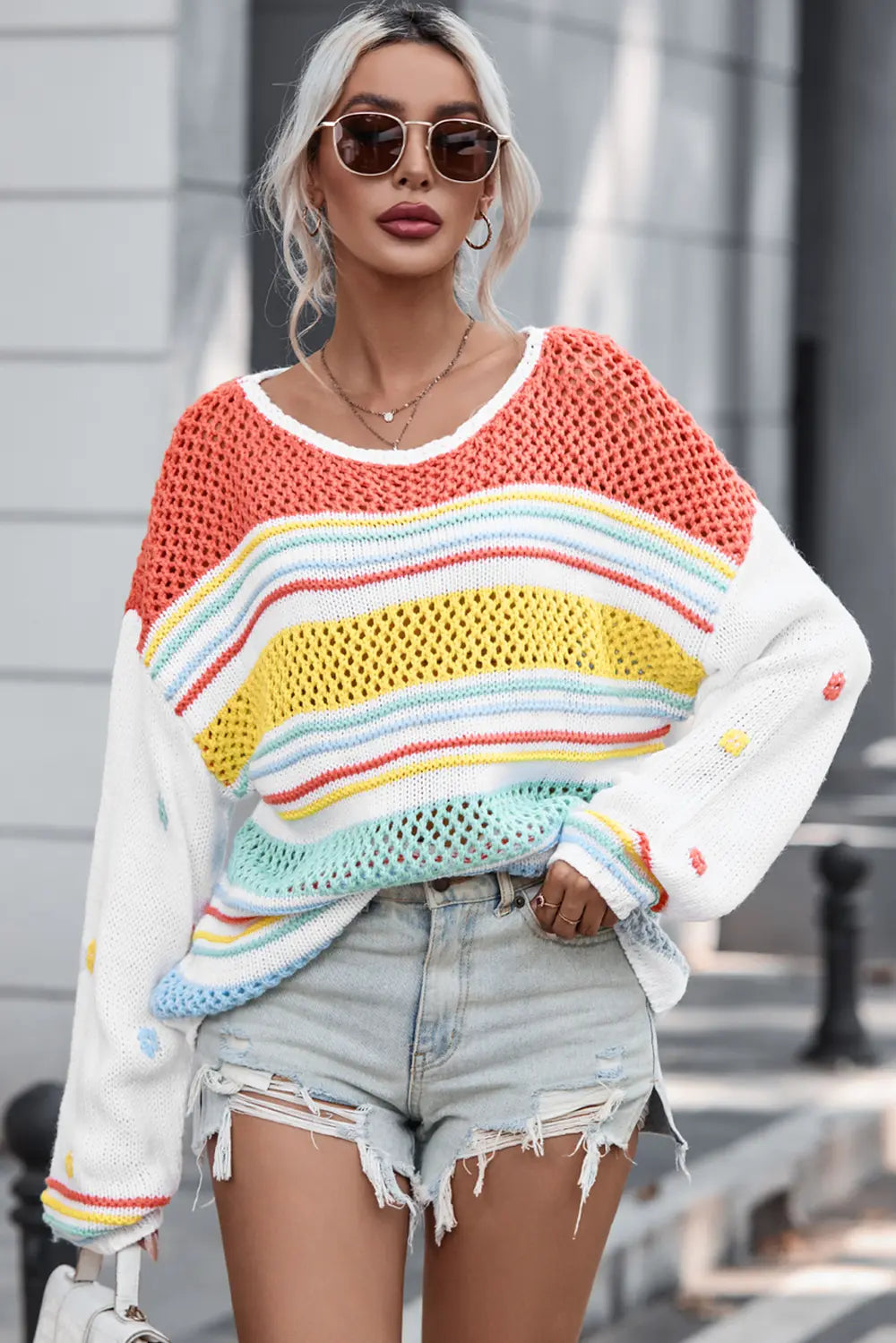 Openwork striped sweater with round neck, long sleeves; orange top and rainbow stripe band