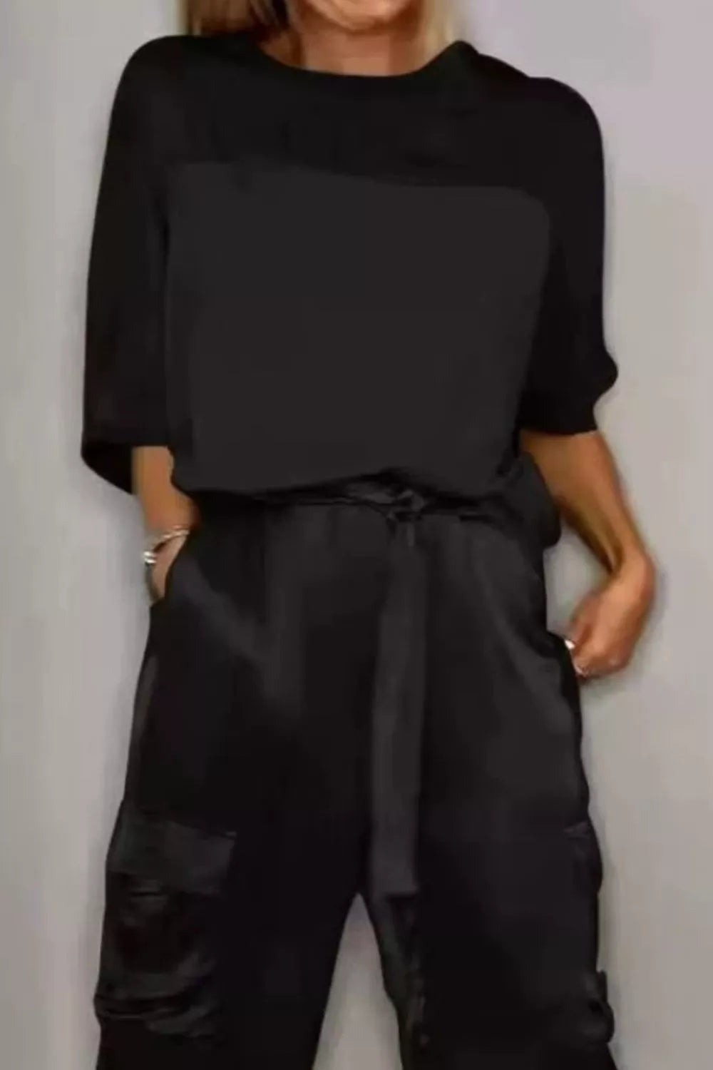 Black satin round-neck top and cargo pants set, drawstring waist, draped sleeves