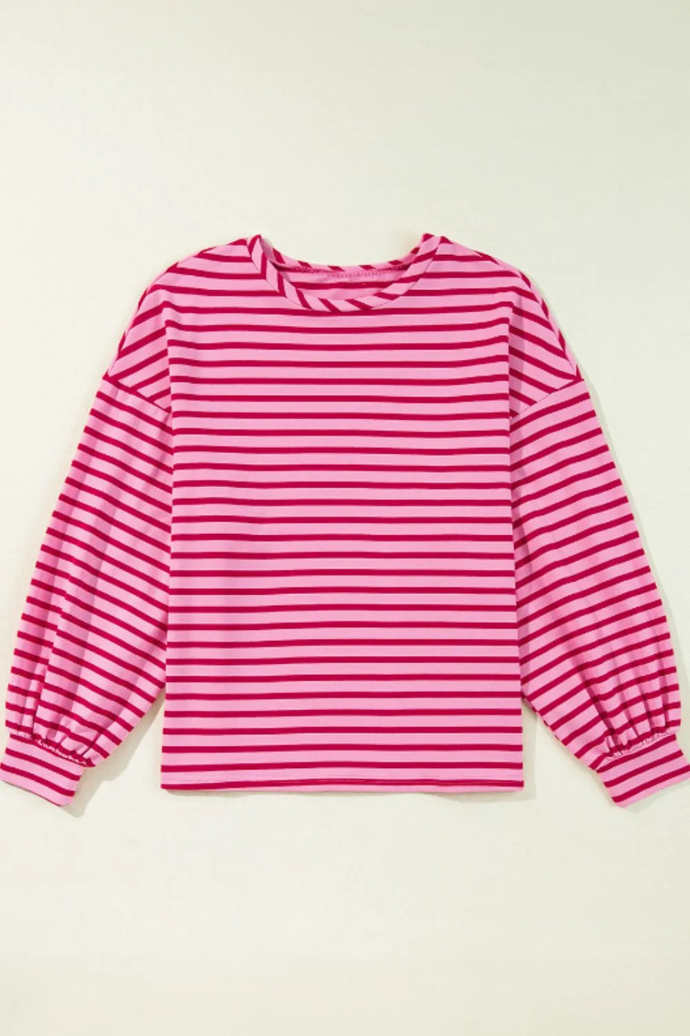 Hot pink striped long-sleeve sweatshirt with round neck and slightly gathered cuffs.
