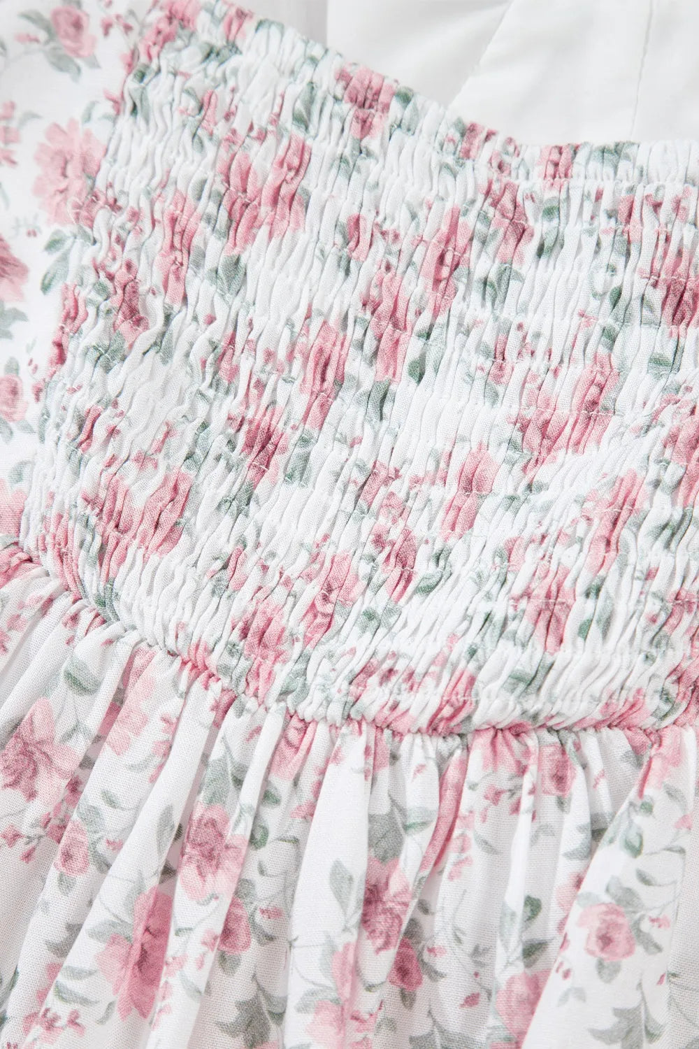 Smocked floral peplum tank top in blush pink with fluttery ruffle hem
