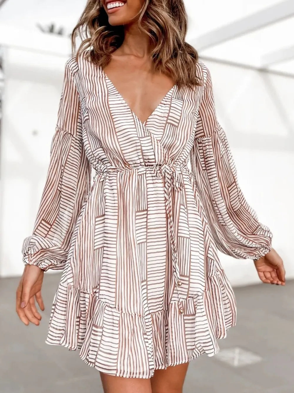 Camel-and-white striped long-sleeve surplice mini dress with V-neck and tiered hem