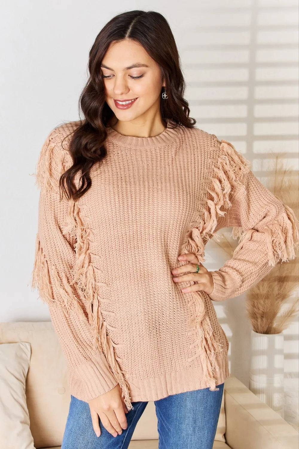 Dusty pink long sleeve sweater with fringe tassel details on sleeves and shoulders