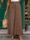 Brown wide-leg pants with elastic drawstring waist, textured fabric