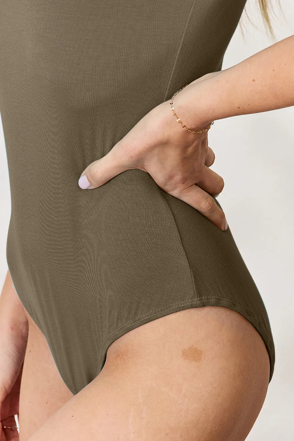Olive short-sleeve round-neck full-size bodysuit, hip and leg opening detail
