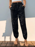 Black lace elastic-waist pants with front pockets, gathered cuffs
