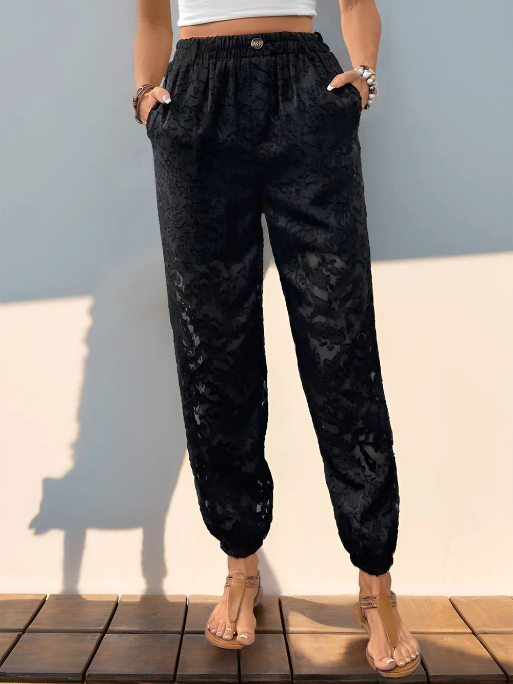Black lace elastic-waist pants with front pockets, gathered cuffs