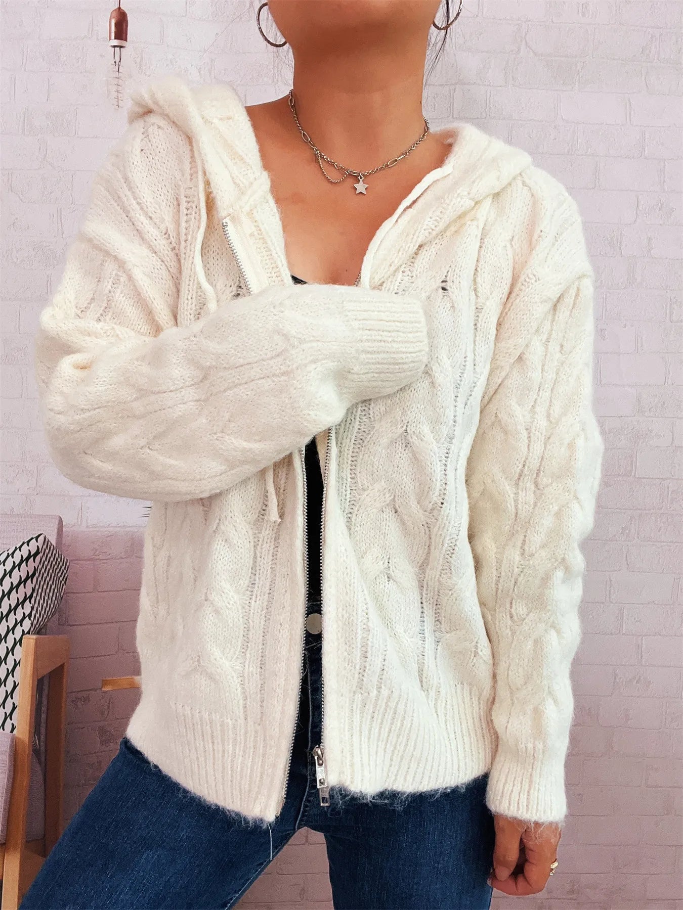 White cable knit hooded zip-up cardigan with front zipper and ribbed cuffs