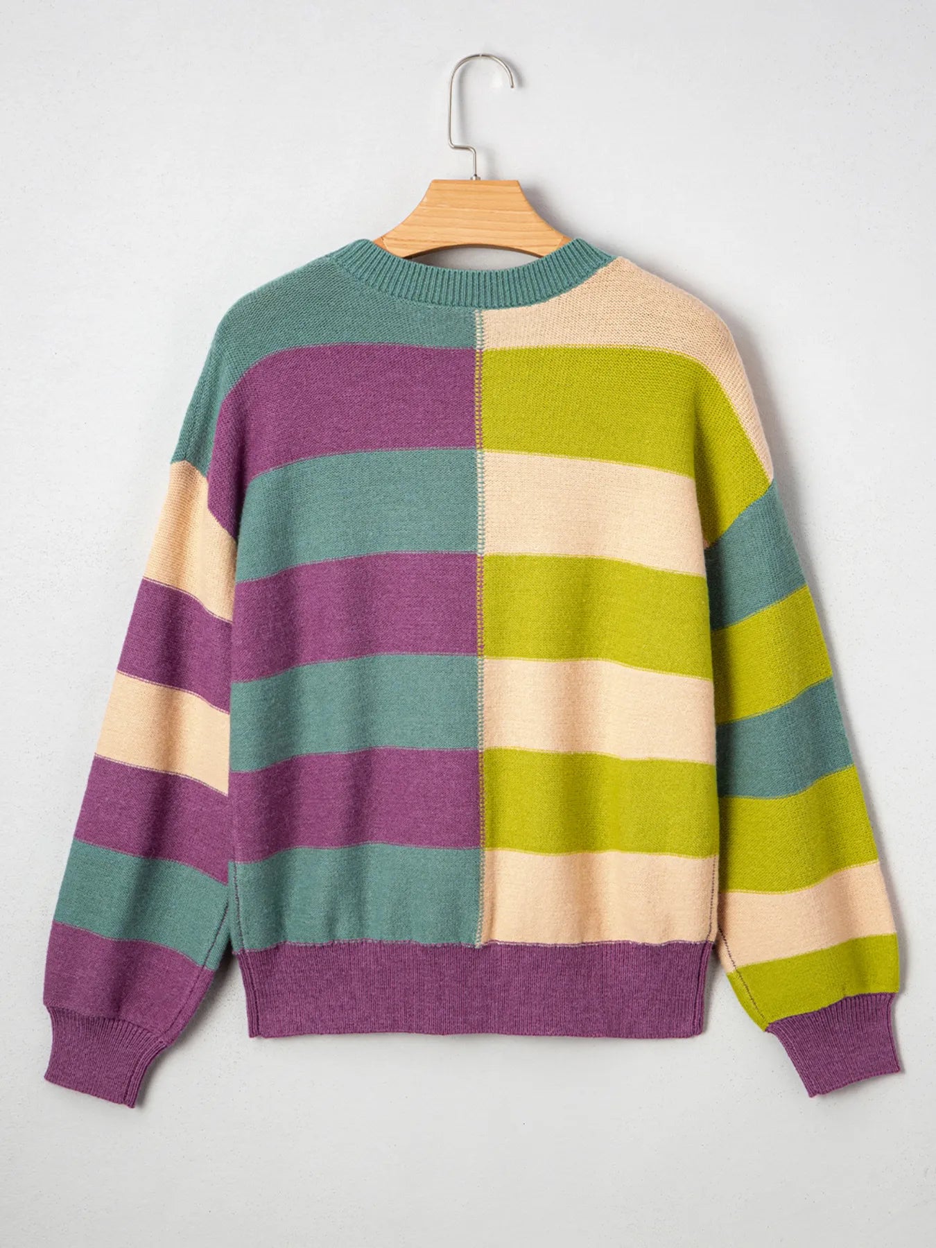 Multicolor striped sweater on hanger, crew neck and ribbed hem with block stripes