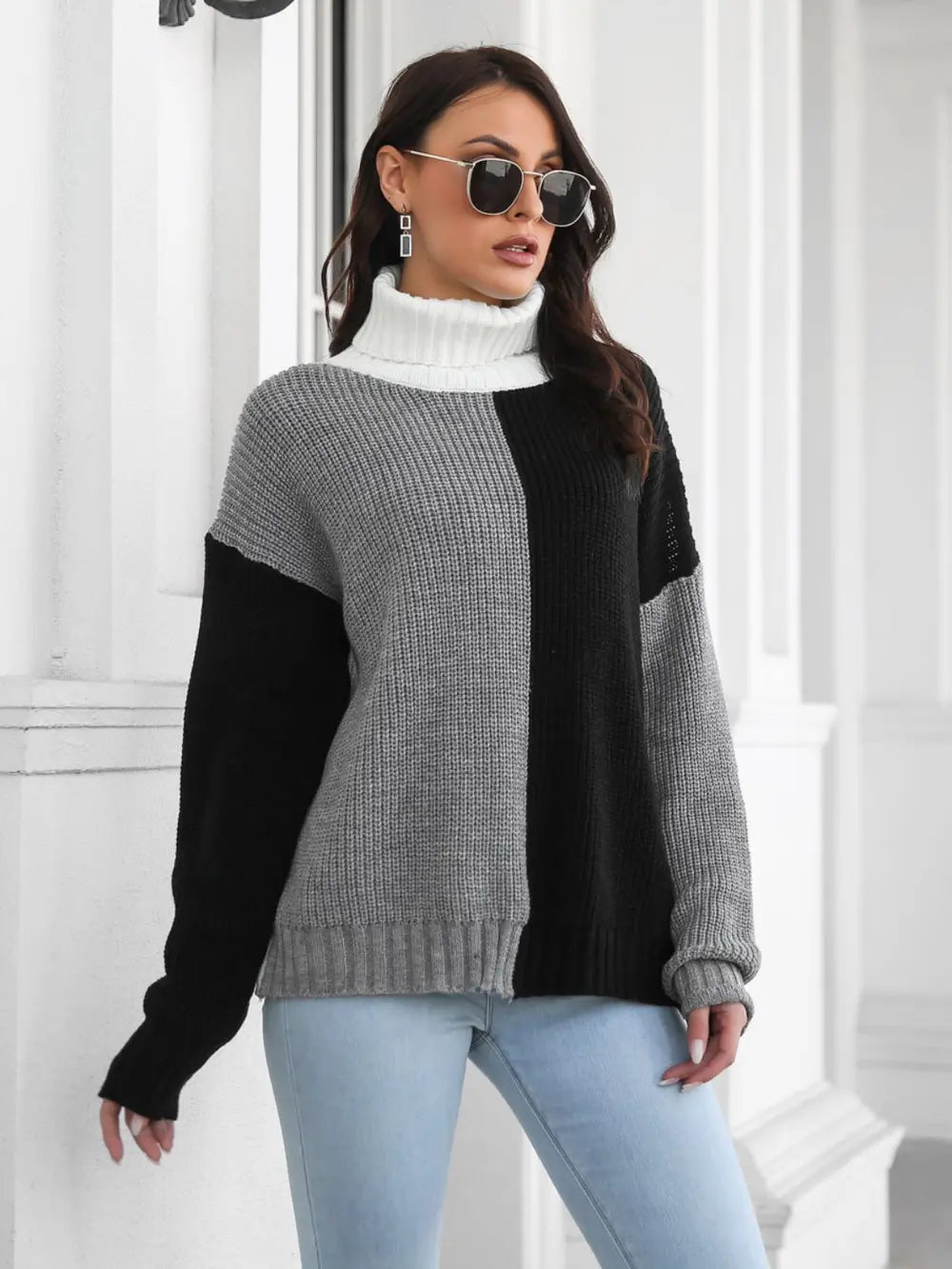 Color-block turtleneck sweater, long sleeves with ribbed cuffs, gray body with black side panels.