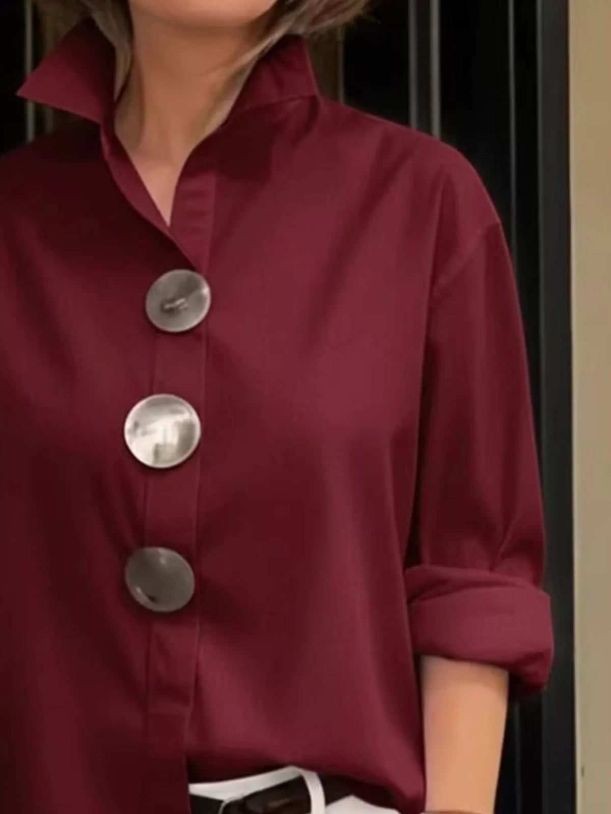 Wine red long-sleeve button shirt with metallic round buttons and point collar, close-up