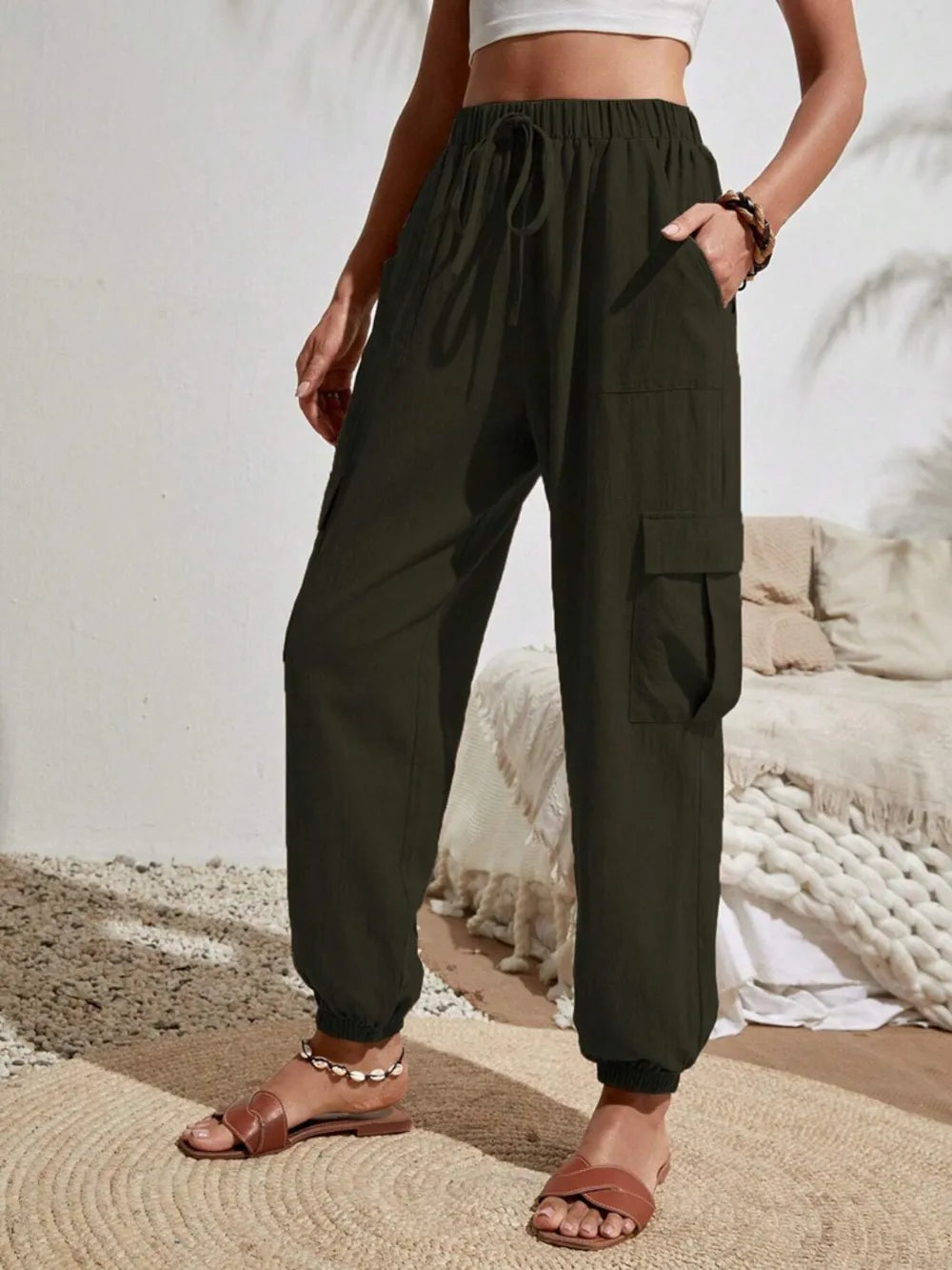 Dark green drawstring cargo joggers with side cargo flap pockets and elastic ankles