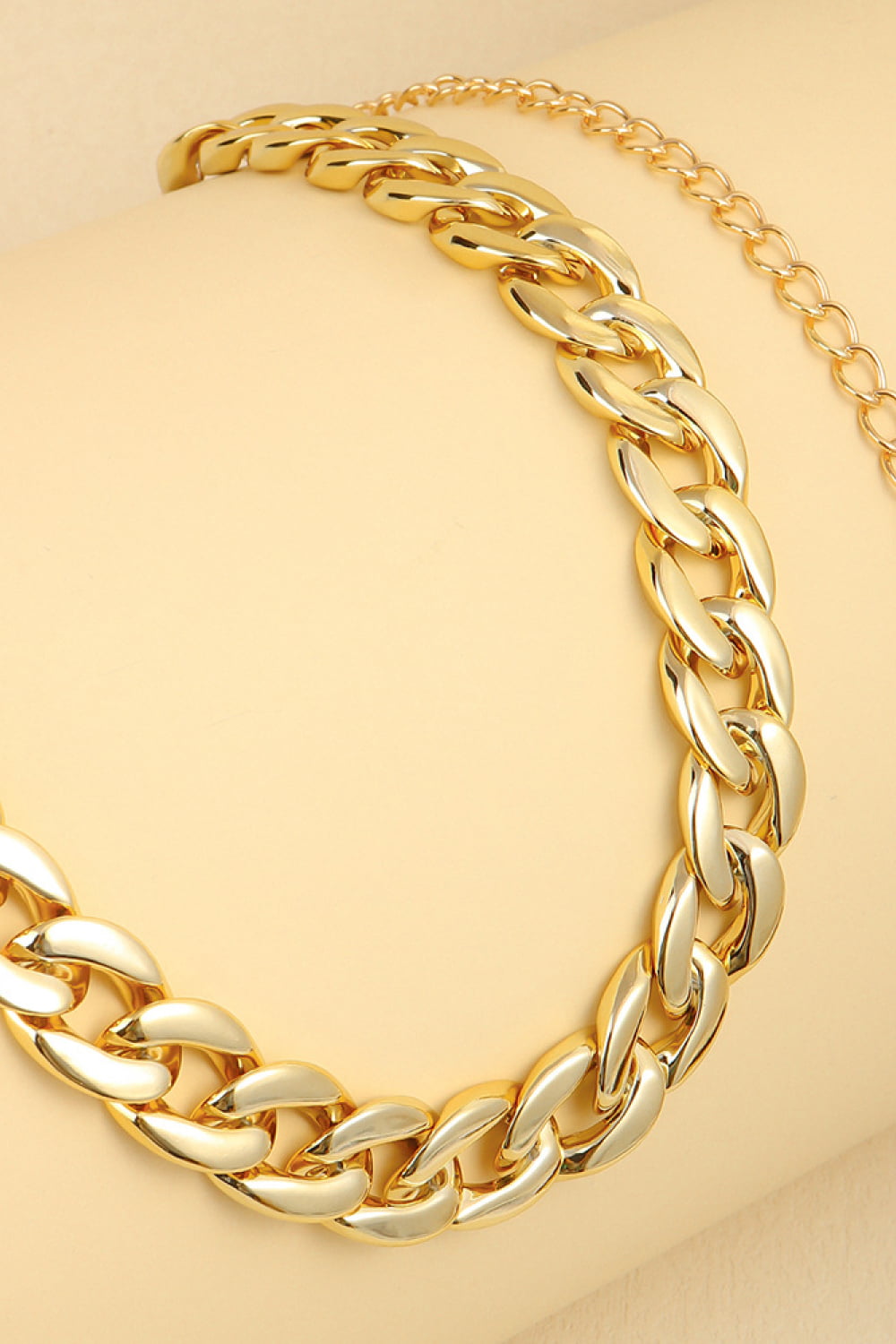 Gold curb chain belt close-up with chunky interlocking links