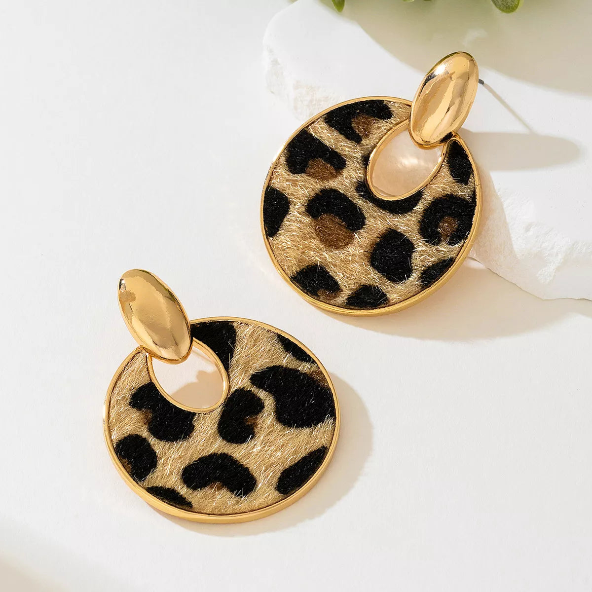 Gold-tone leopard circle dangle earrings with oval top loops, front view