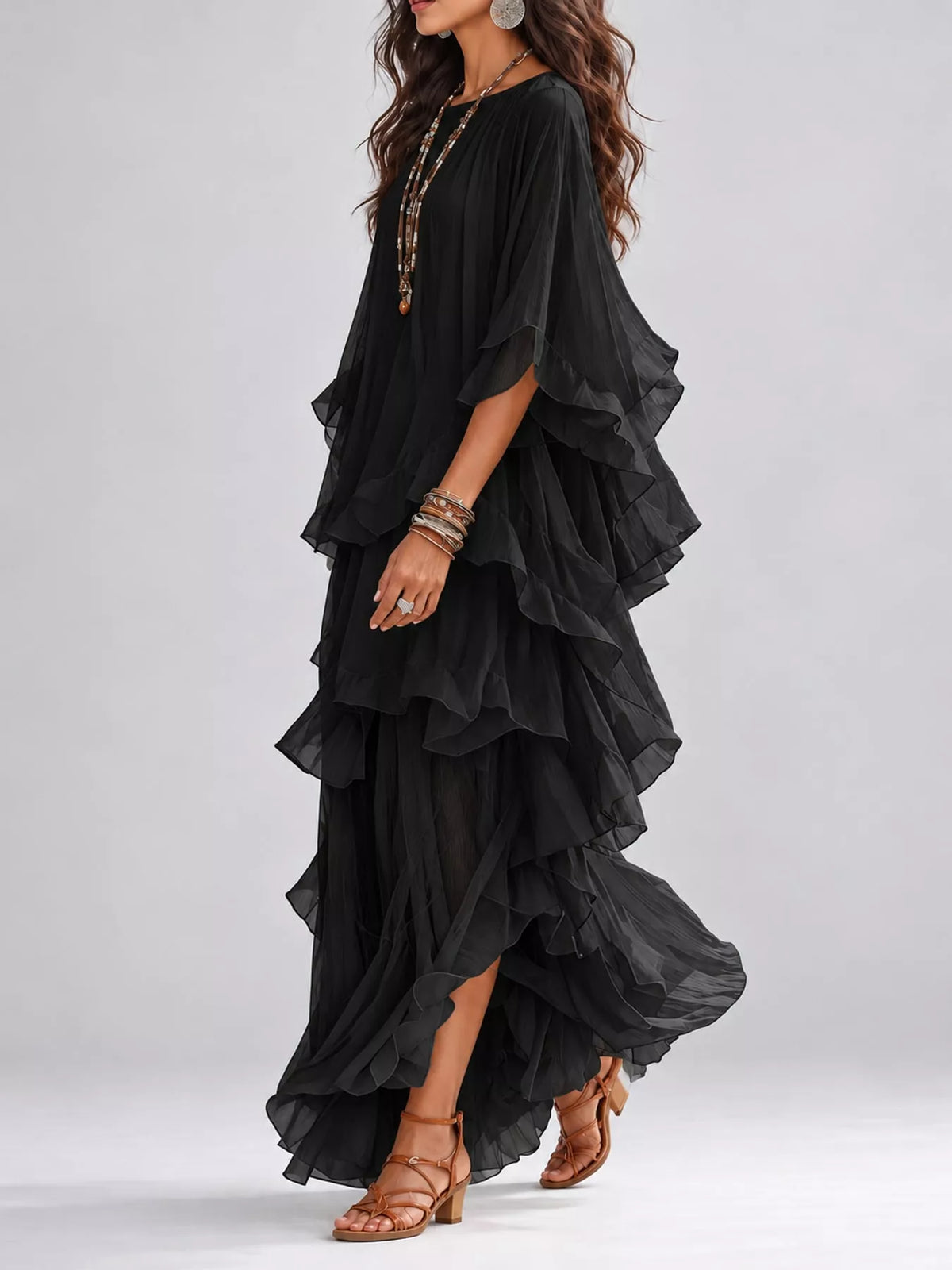Black tiered maxi dress with cascading ruffle layers and asymmetrical hem