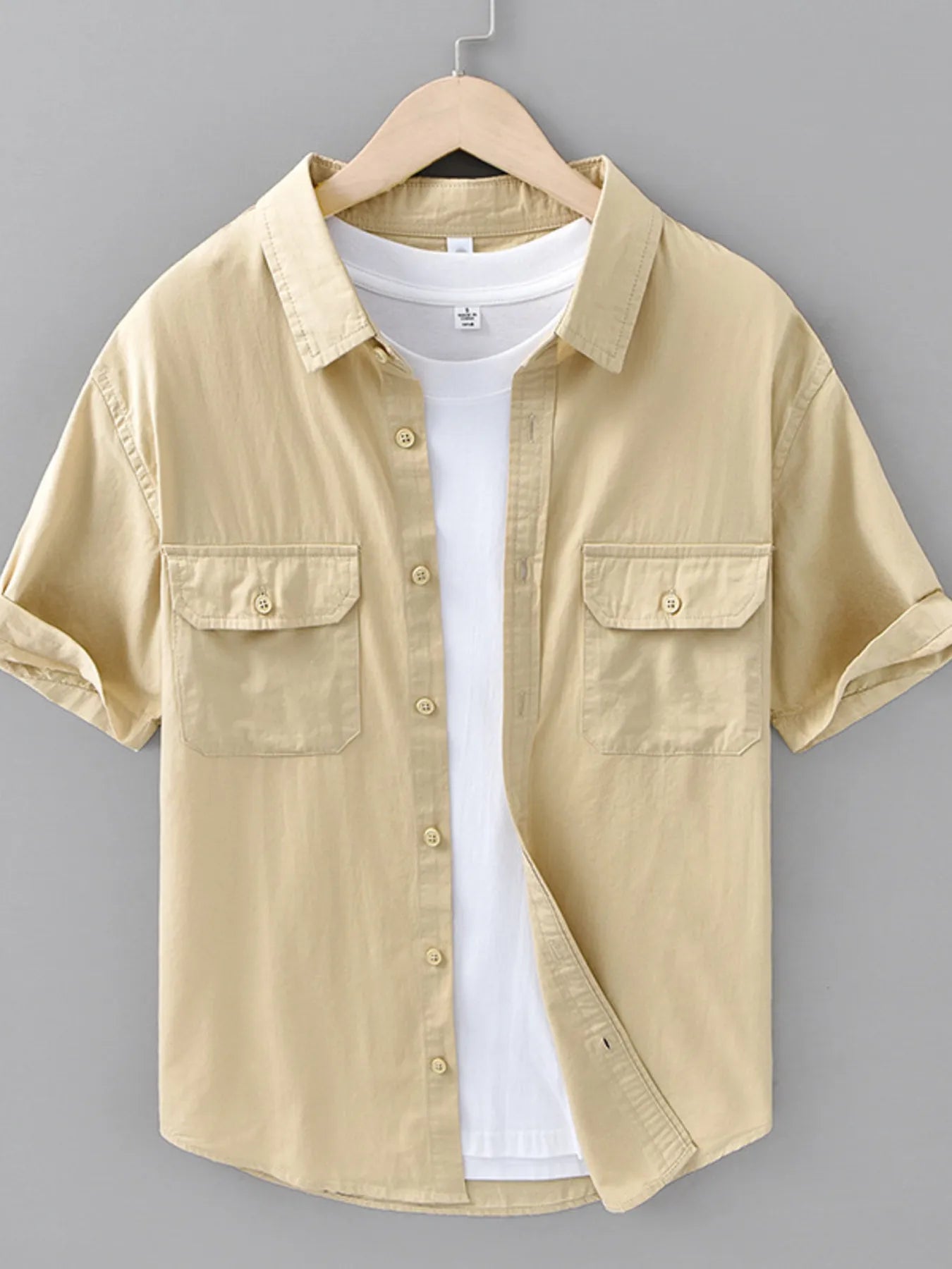 Khaki short-sleeve button-up shirt with chest flap pockets and front buttons