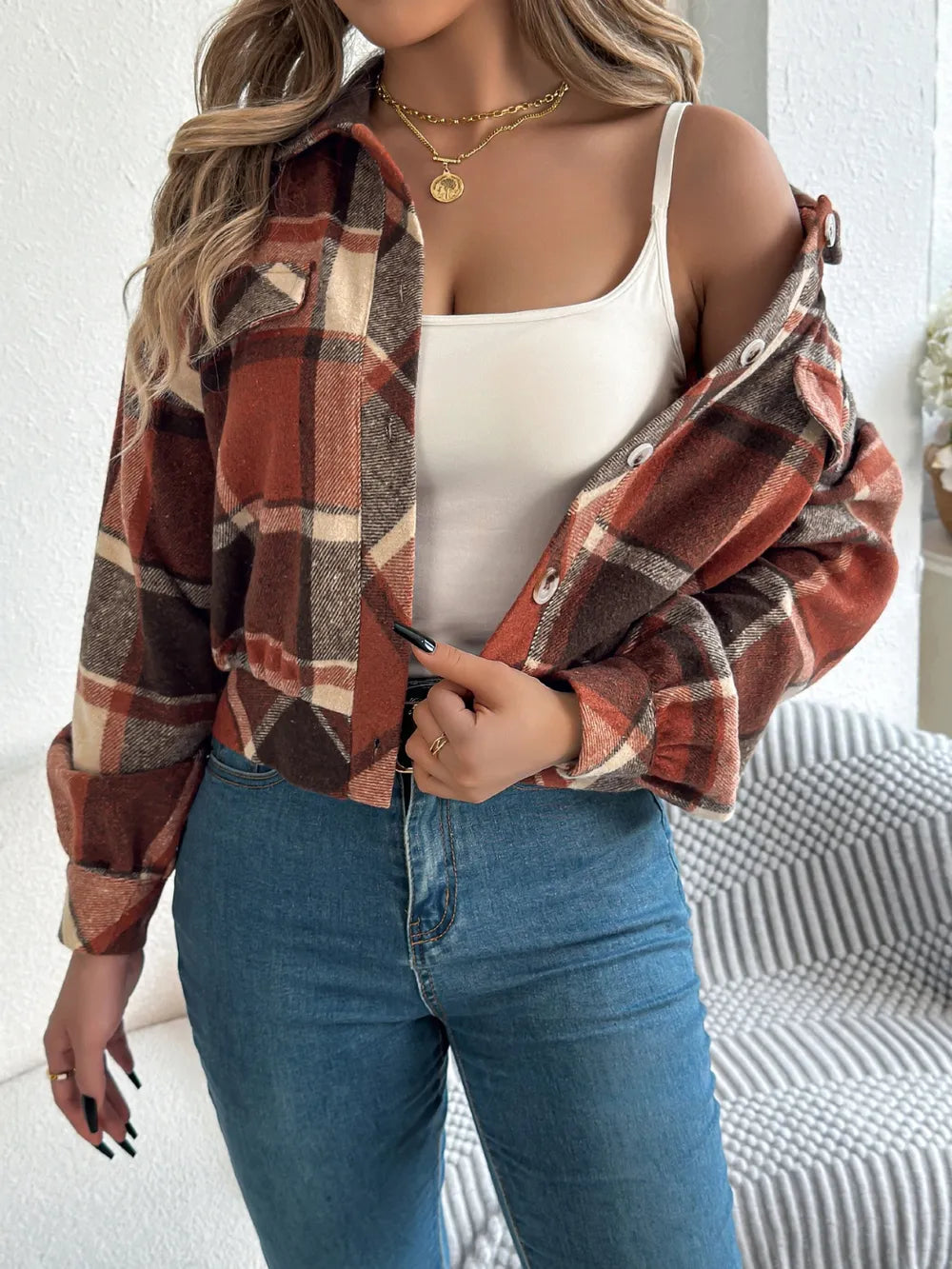 Plaid button-up long-sleeve jacket worn over a white scoop-neck top