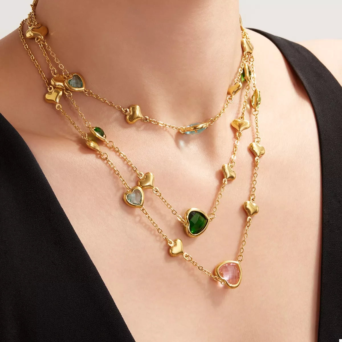 Gold-plated heart necklace with green, pink, and blue glass heart charms