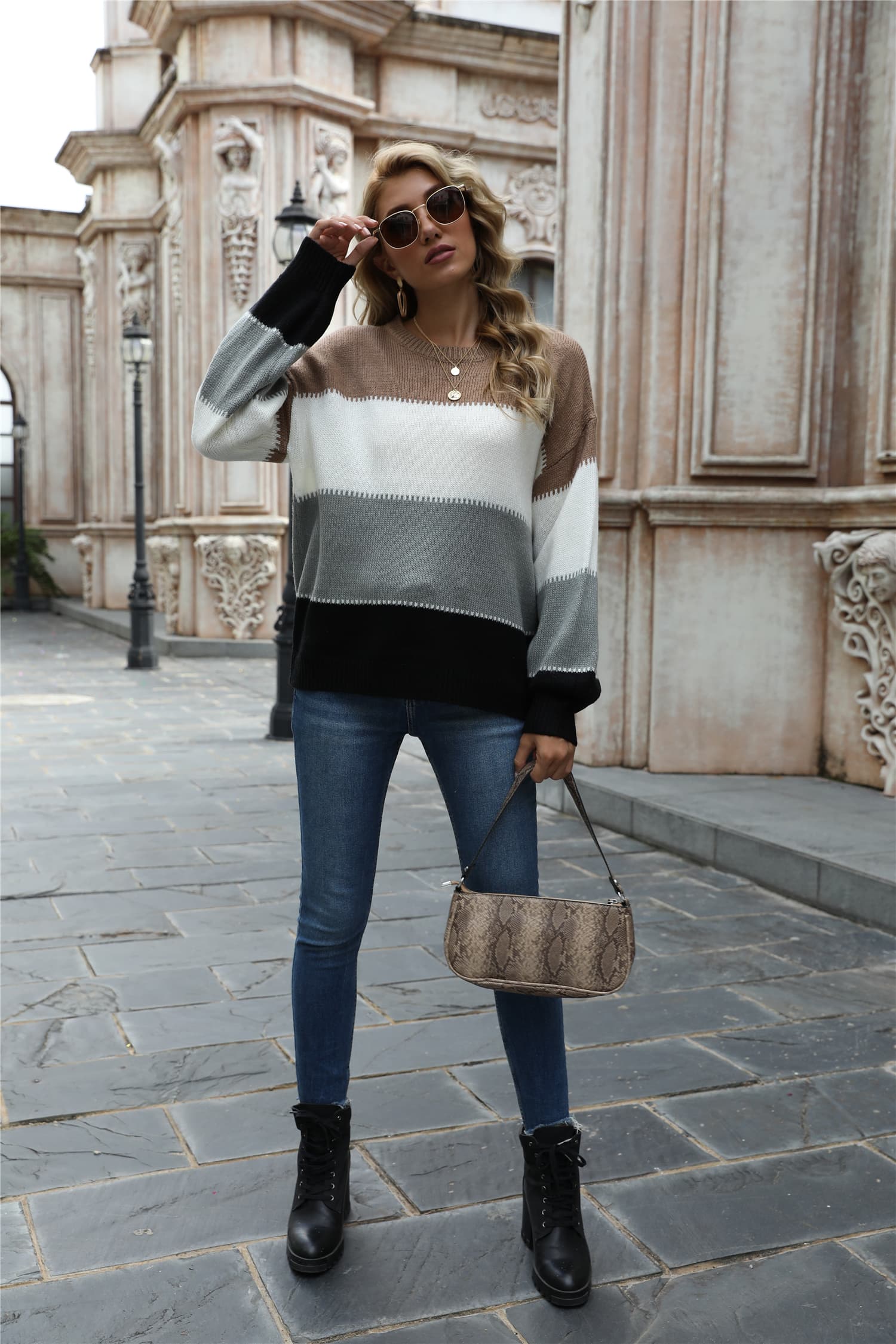 Front view color block round neck sweater in tan, white, dark gray with black cuffed sleeves