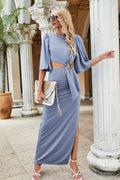 Light blue maxi dress with cutout waist, tie belt, puff sleeves, and side slit