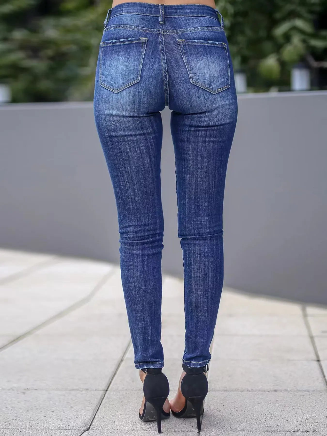 Blue skinny fit washed jeans, back view with two back pockets and belt loops.