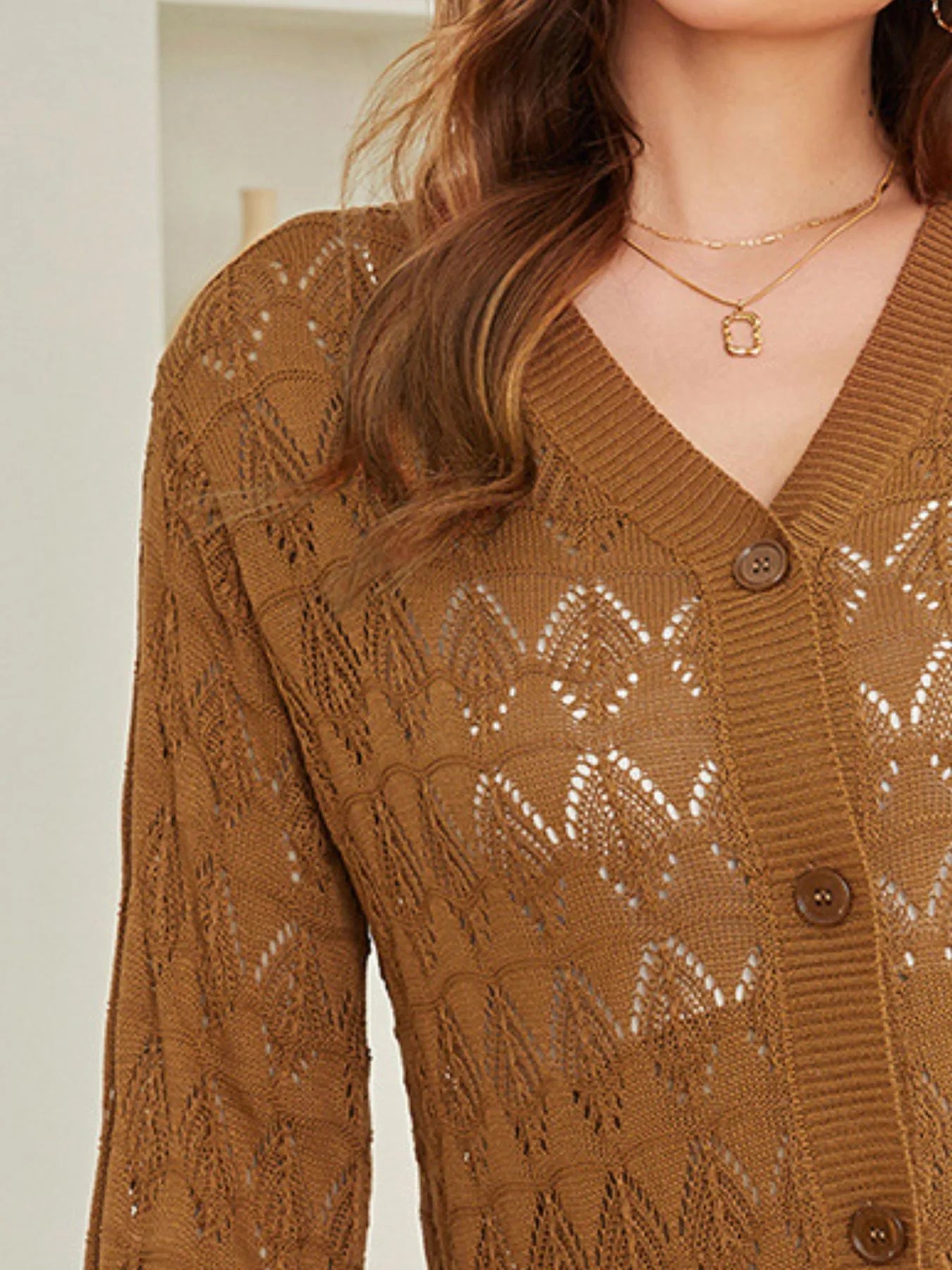 Brown openwork button-up cardigan close-up with button front and diamond knit detailing