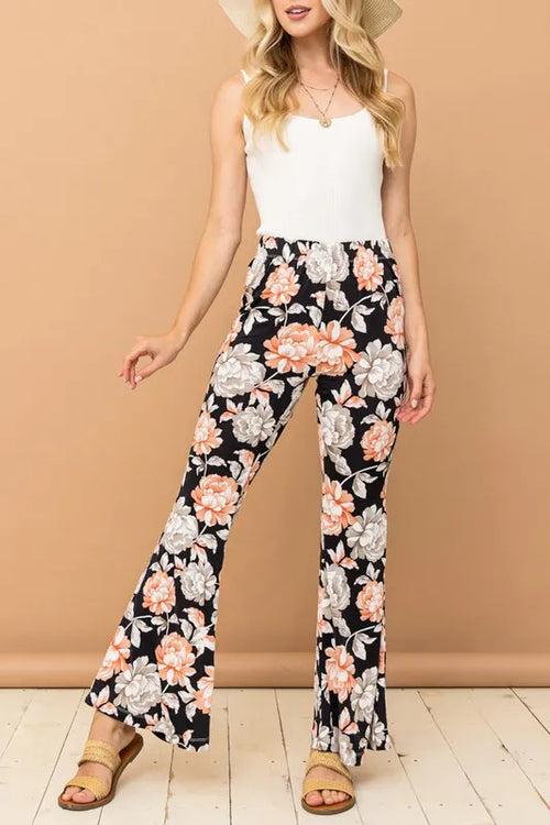 Floral bell-bottom pants with black background and orange, white, and gray flowers