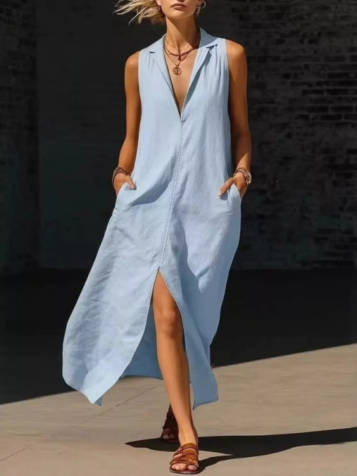 Light blue sleeveless maxi dress with deep V-neck and side pockets, front slit hem