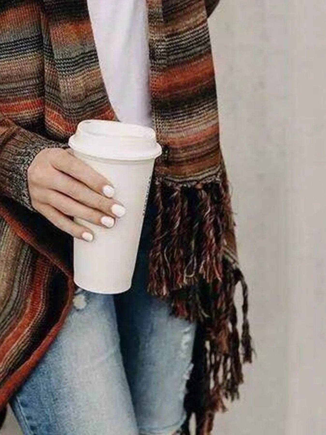 Fringe wrap cardigan with striped pattern and tassel trim at hem
