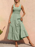Light green tiered smocked wide-strap dress with sleeveless bodice and ruffled skirt tiers.