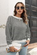 Striped knit sweater with round neck and dropped shoulders, black-and-white