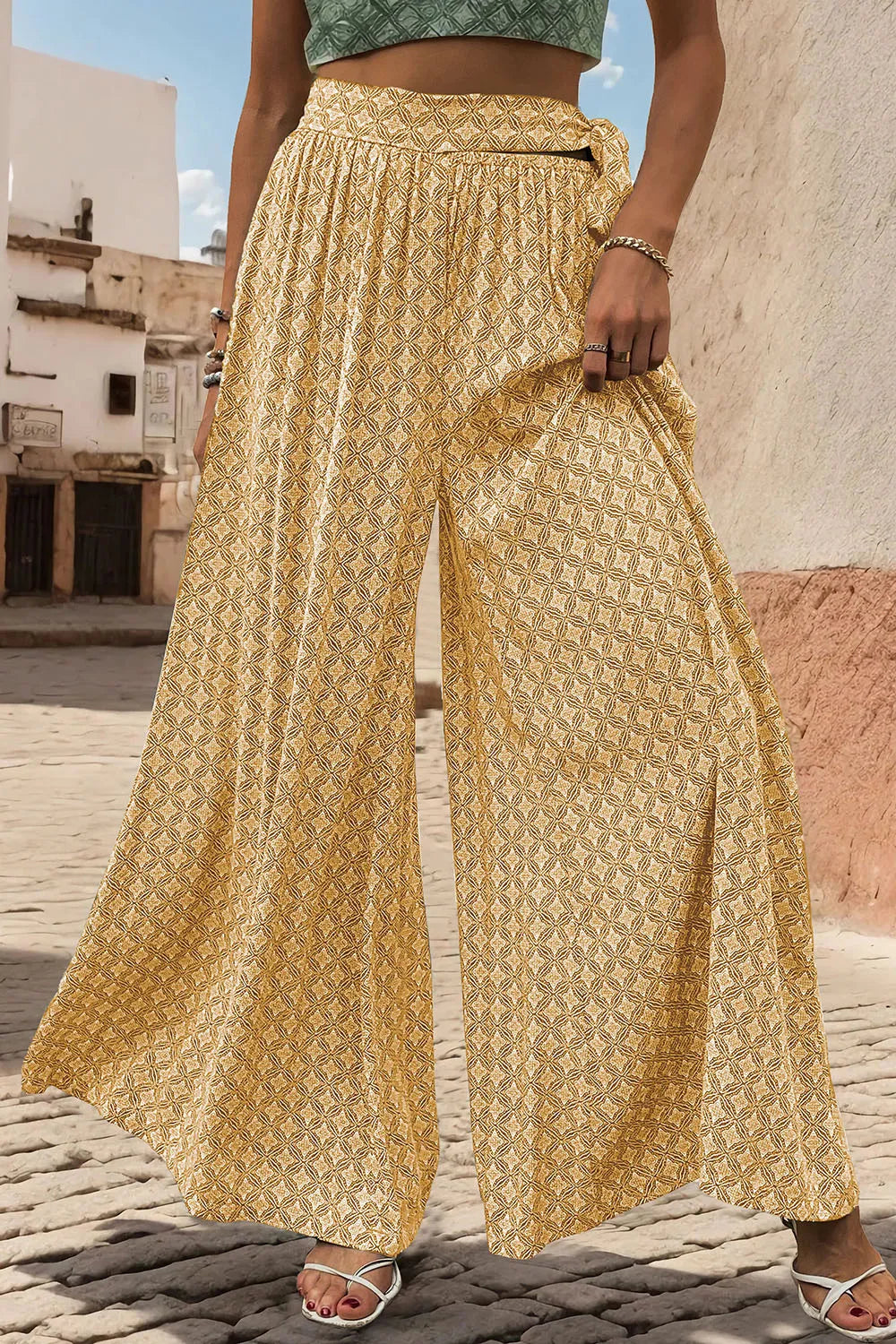 Yellow printed wide-leg pants with tied waist and wide flared legs, relaxed fit