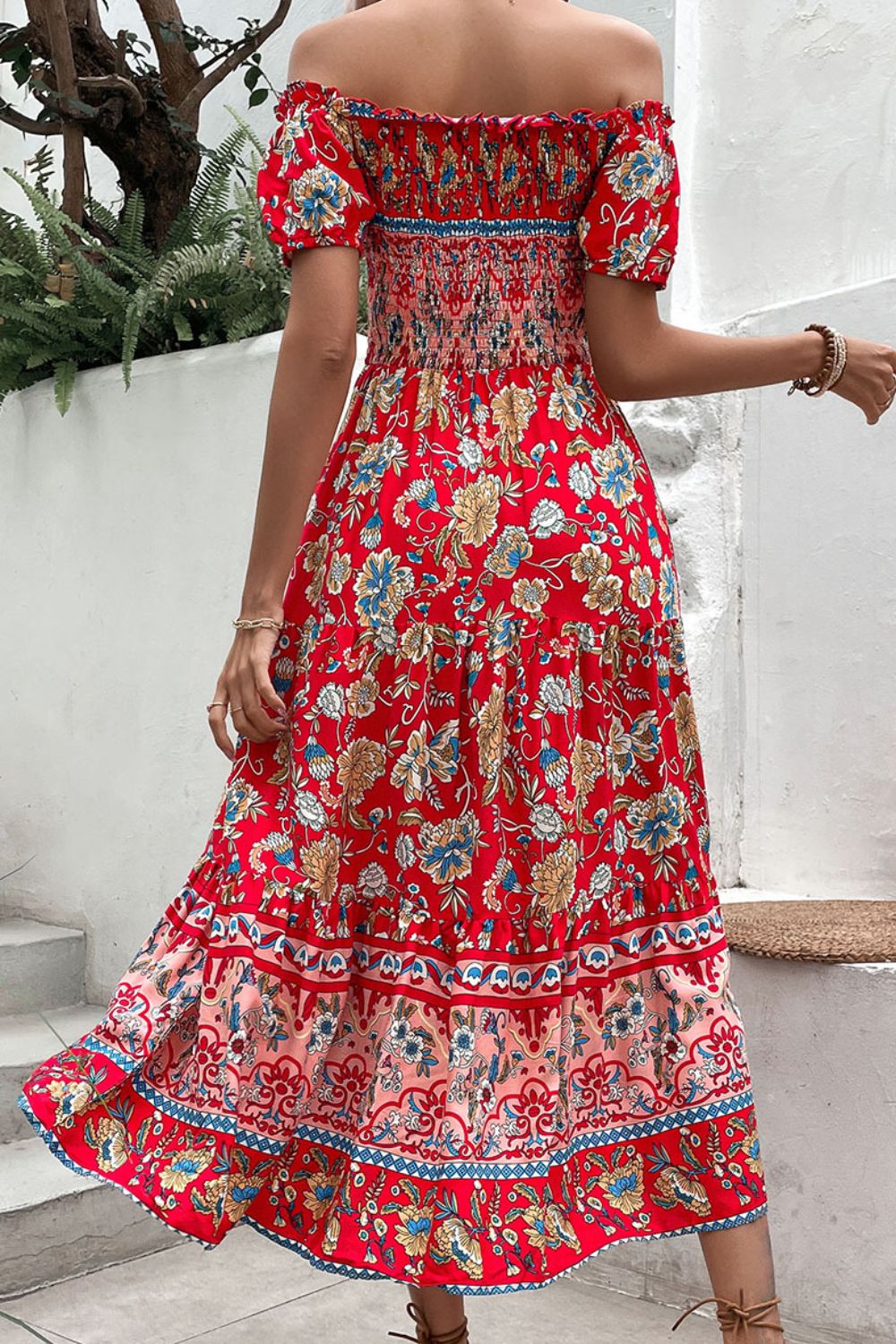 Back view of deep red floral off-shoulder smocked midi dress with tiered hem trim
