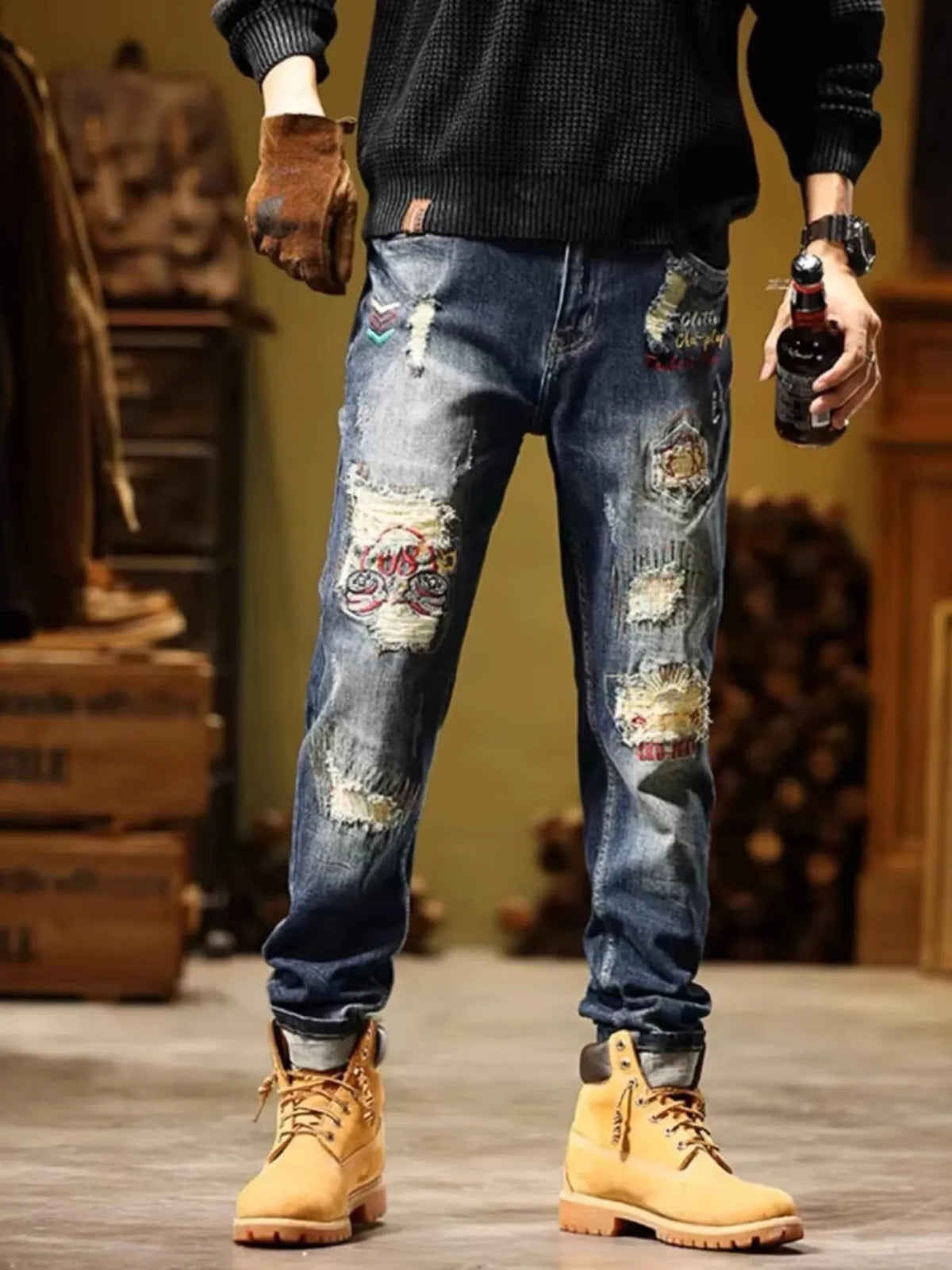 Men's blue slim-fit distressed jeans with multicolor graphic patches and rips