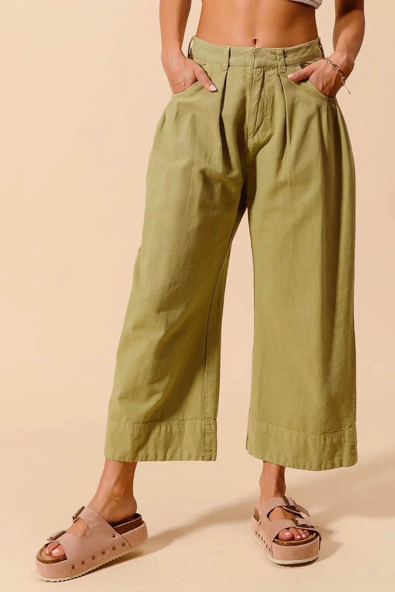 Sage green mid-rise wide-leg chino pants with pleats at the waistband