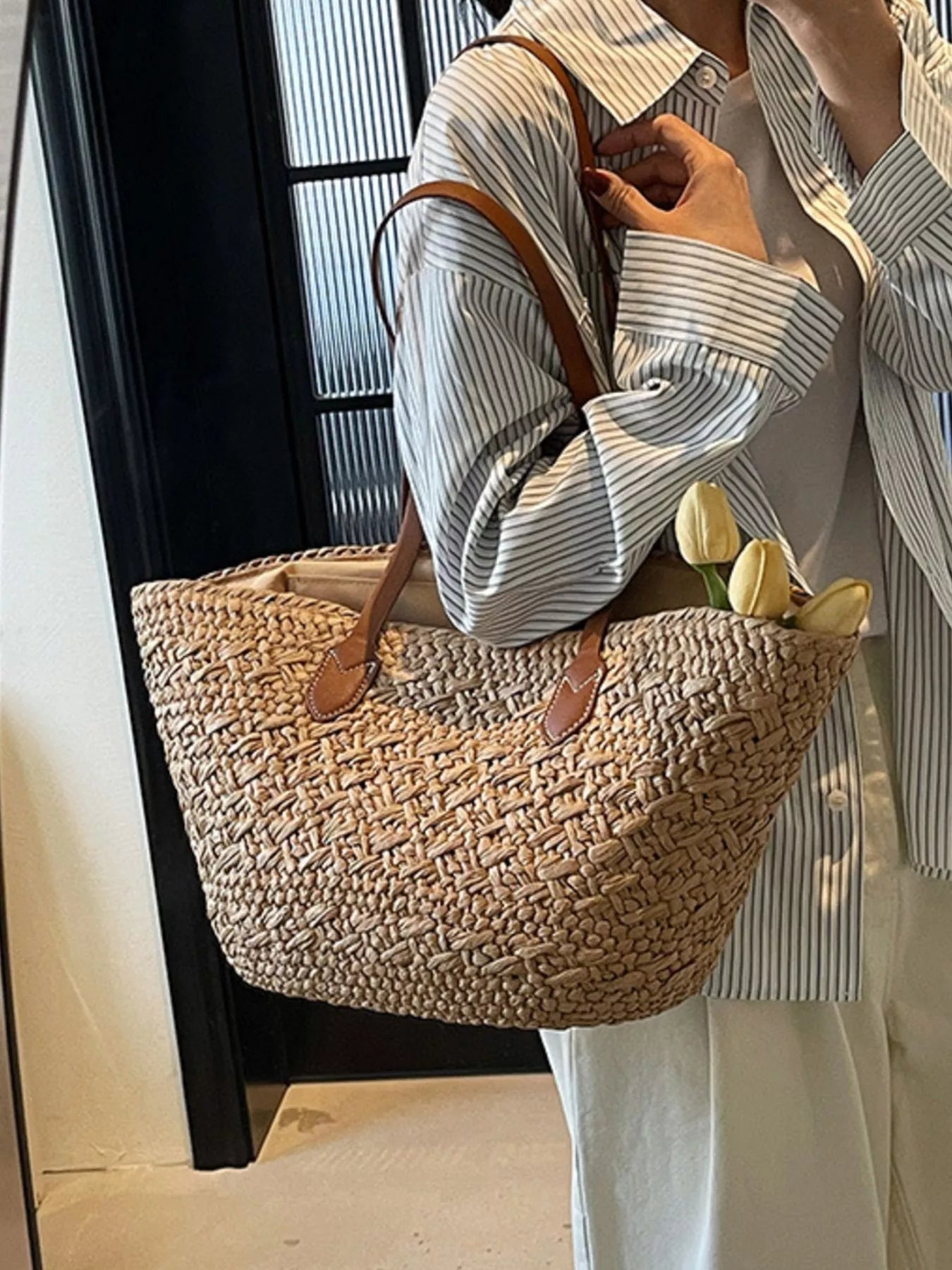 Caramel medium woven tote bag with brown leather handle tabs and shoulder straps