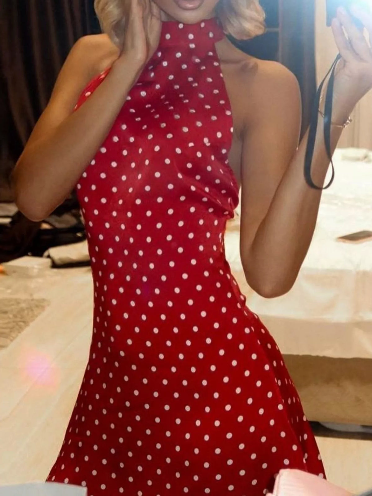 Red halter mini dress with white polka dots and fitted waist