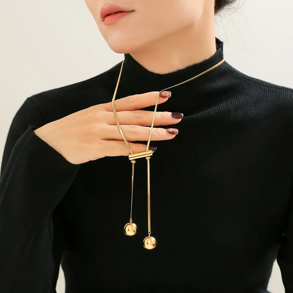 Gold-plated beaded necklace with two strands and small round hollow charms