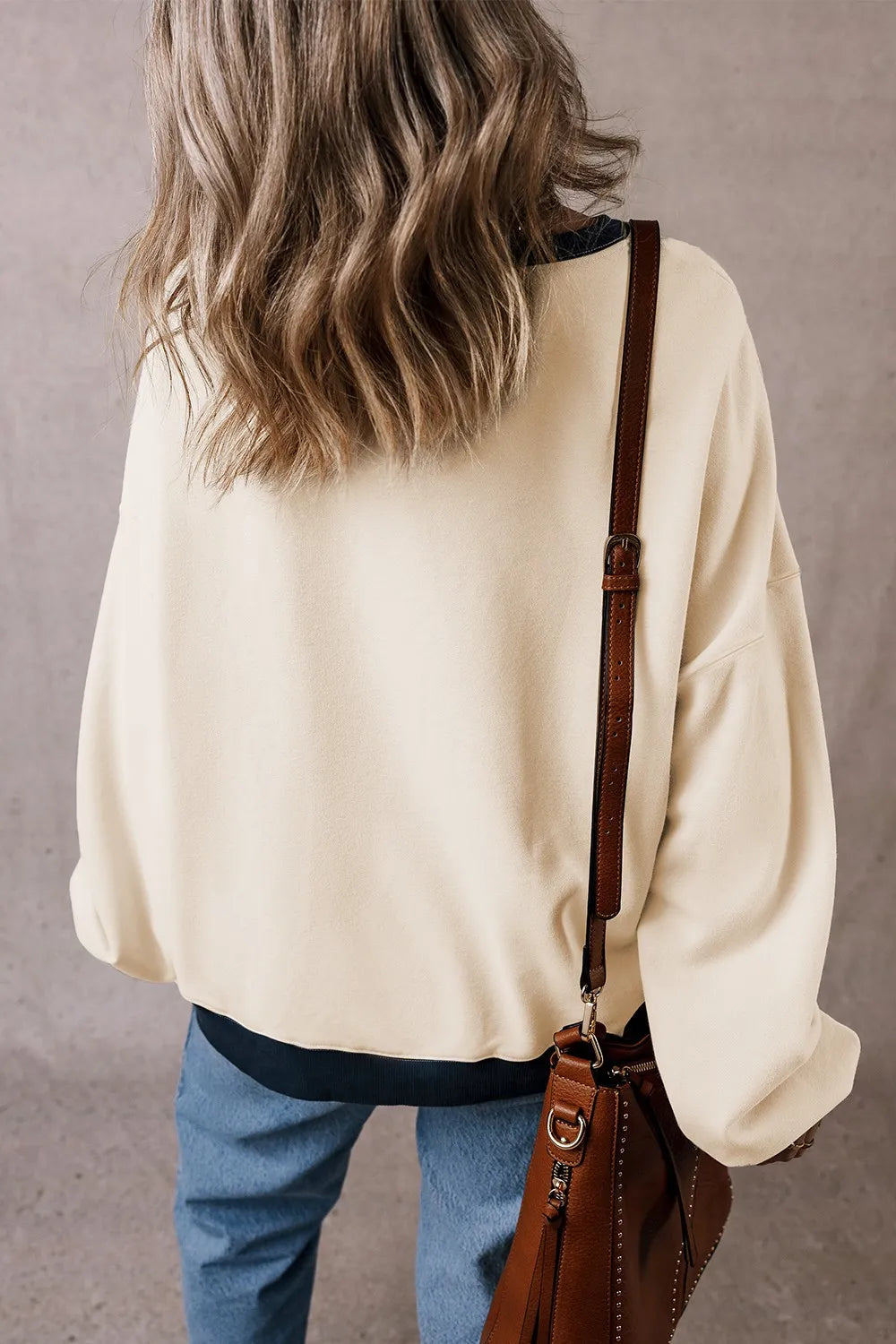 Ivory long-sleeve sweatshirt with ribbed dark hem and contrasting V yoke detail