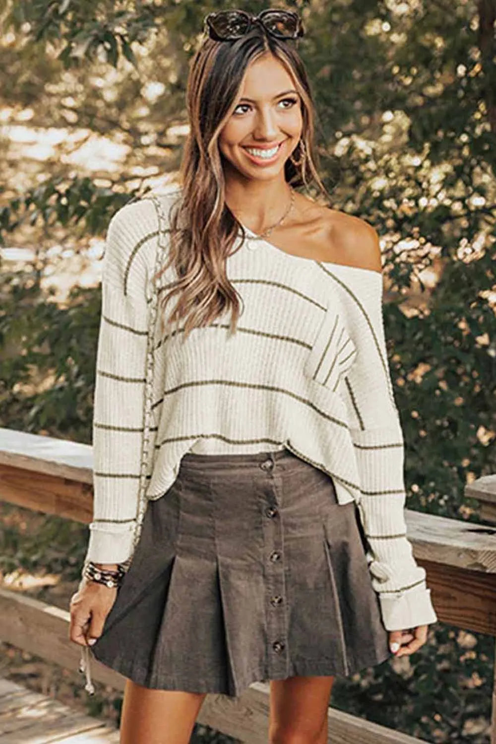 White striped V-neck sweater with wide drop shoulders and ribbed trim
