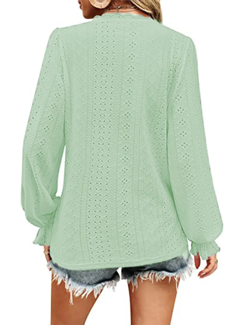 Back view mint green eyelet V-neck blouse with long puff sleeves and gathered cuffs