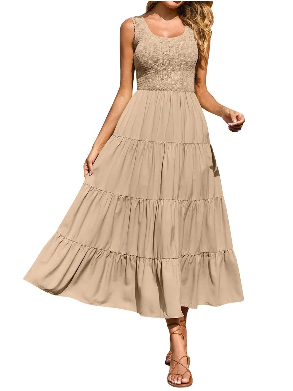 Beige tiered smocked wide-strap dress with tiered skirt ruffles and sleeveless smocked top.