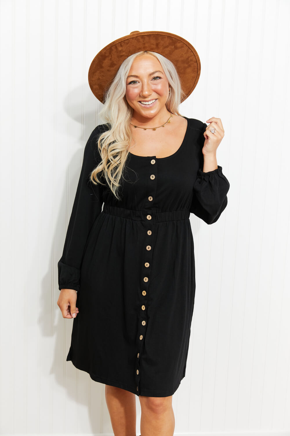 Black long sleeve mini dress with scoop neck and button front; empire waist gathers