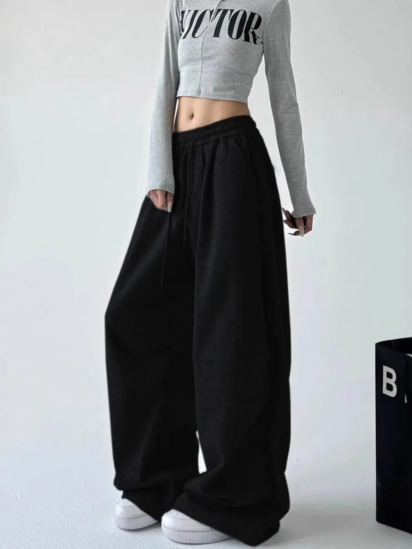 Black oversized wide-leg drawstring pants with elastic waistband and roomy fit