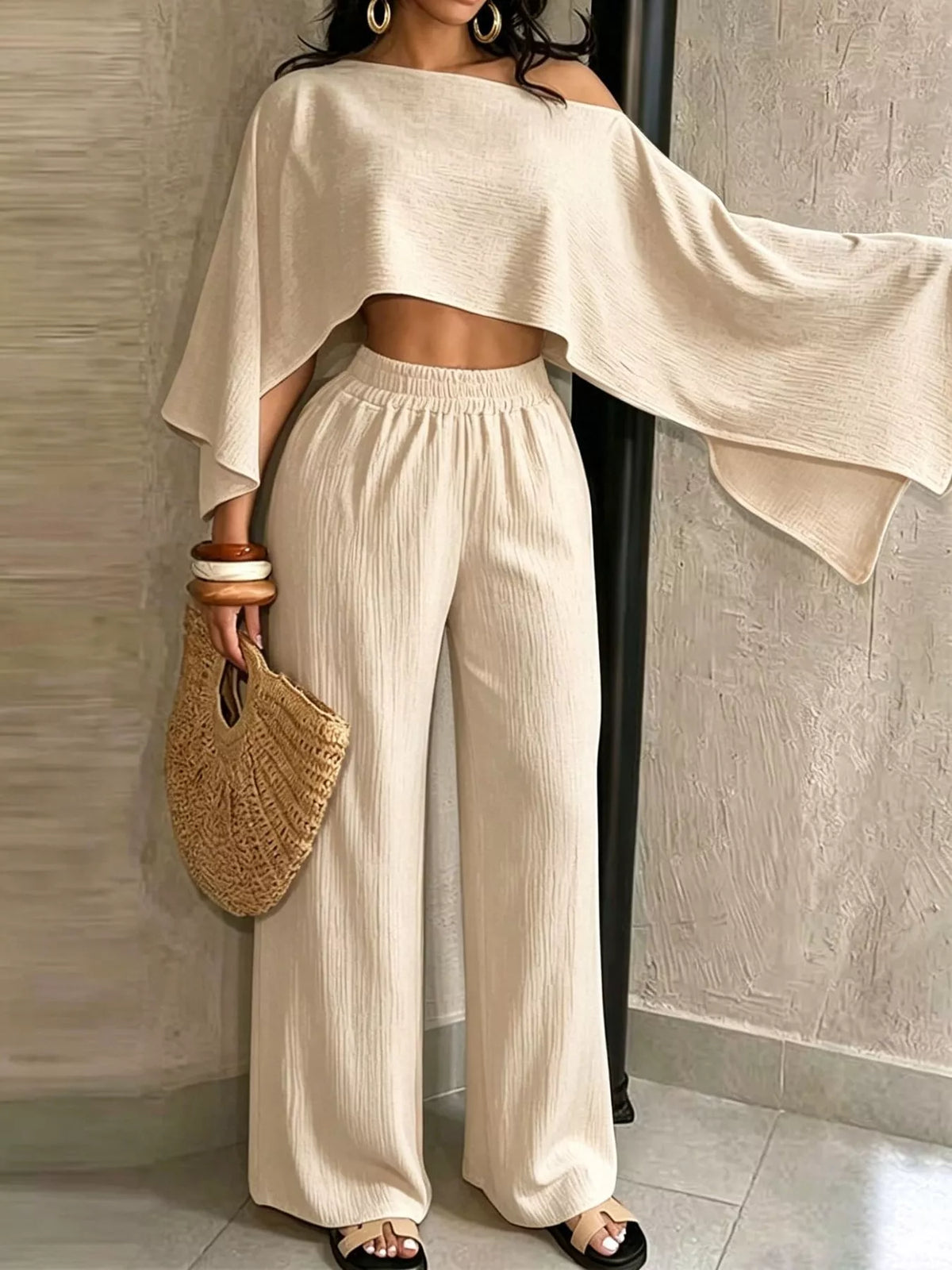 Cream boat-neck crop top and elastic-waist wide-leg pants, side view.