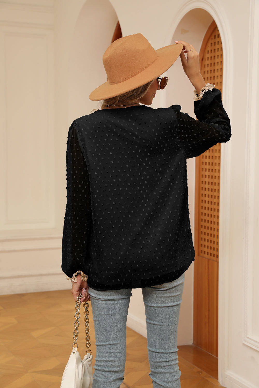 Black Swiss-dot V-neck blouse with contrast trim, long sleeves (back view)