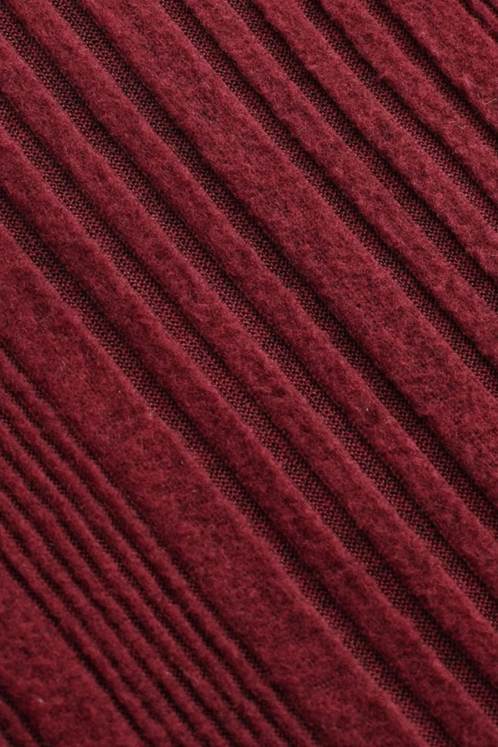 Deep red ribbed knit fabric with fine vertical texture