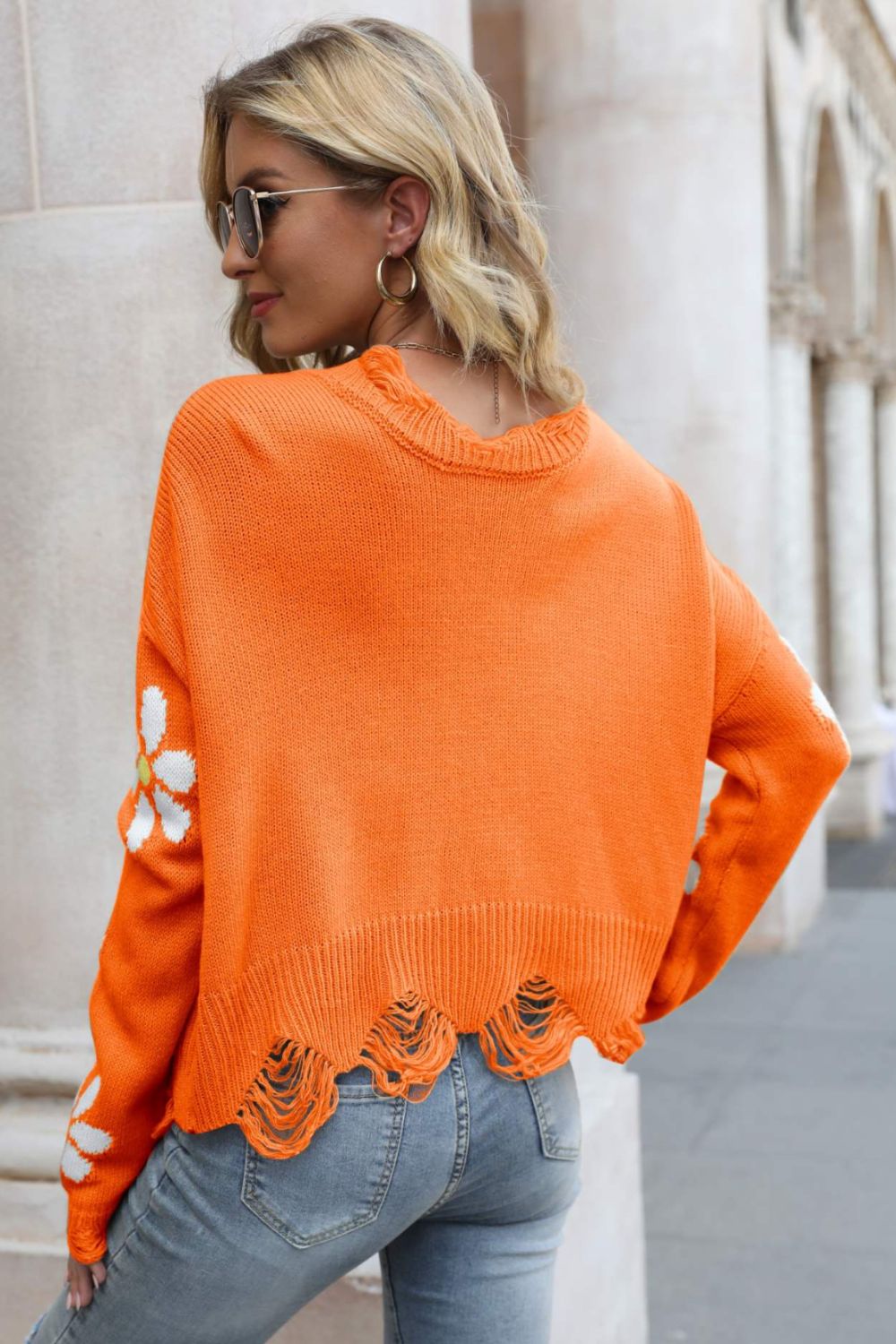 Orange distressed ribbed-trim sweater with white daisy sleeves and frayed hem
